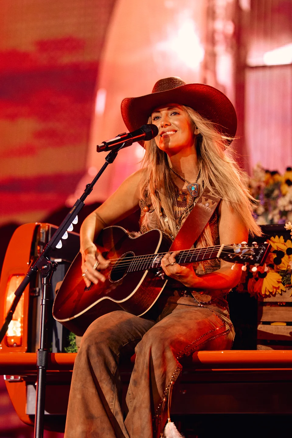 Lainey Wilson cantando em apresentação em Nashville em 2024